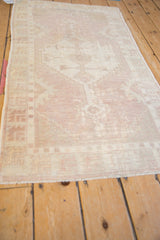 Distressed Oushak rug featuring a softly worn texture and muted dusty mauve, ivory colors.