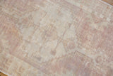 Distressed Vintage Oushak rug, showing worn dusty mauve and ivory geometric floral motifs.