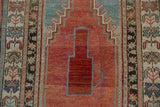 Distressed Anatolian rug detail, red prayer mehrab field with aqua blue ewer design.