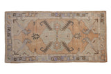 Distressed Oushak runner: oversize medallion, serrated leaves, dusty gold, pale blue, ivory.