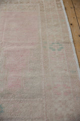 Close-up view of the even, short pile and soft abrashes on a distressed Turkish Oushak rug.