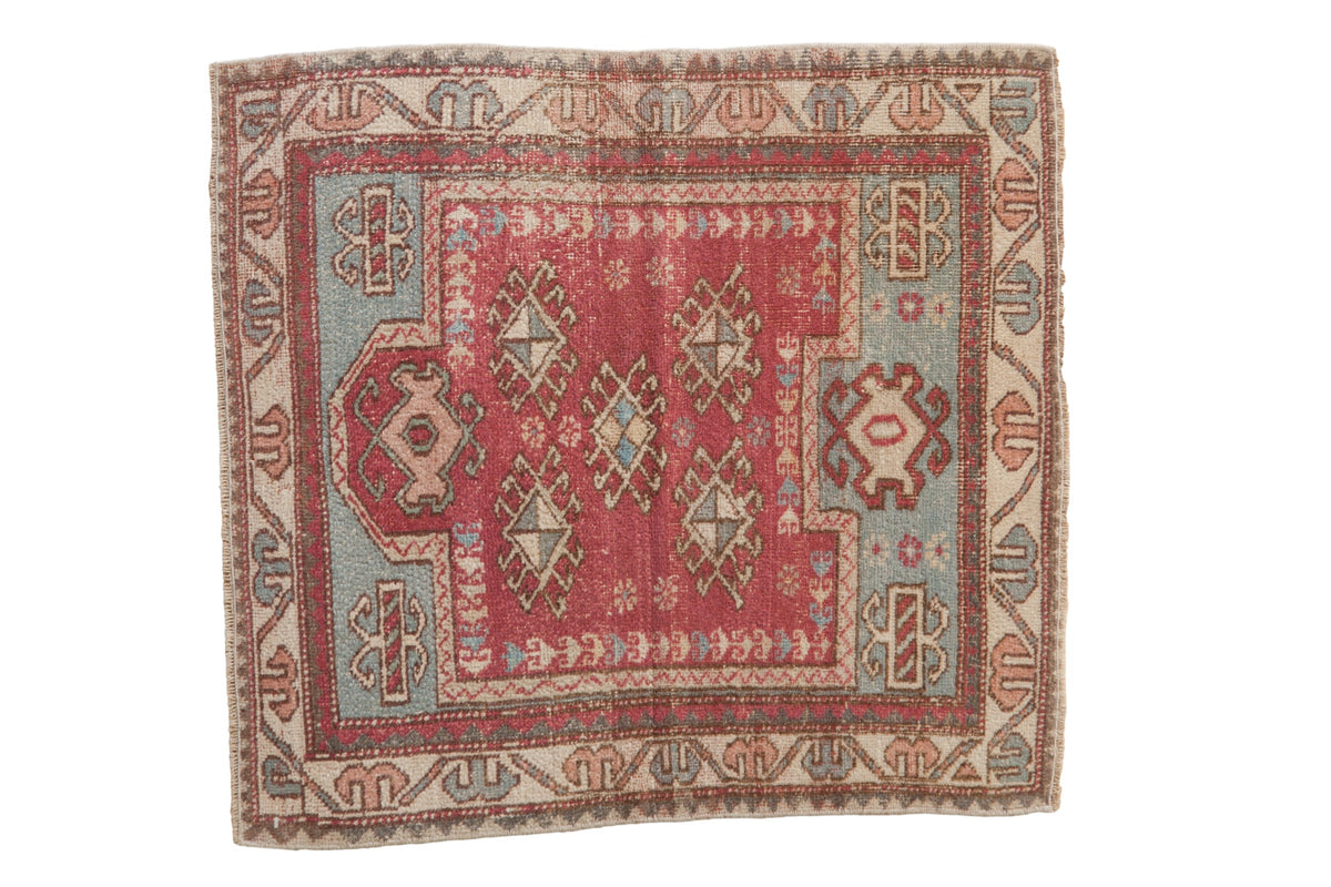 Vintage distressed Oushak rug with pinwheel guls in dusty raspberry, powder blue, and beige.