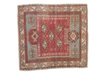 Vintage distressed Oushak rug with pinwheel guls in dusty raspberry, powder blue, and beige.