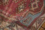 Textured knot heads and distressed pile on a vintage Oushak rug in raspberry and powder blue.