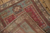 Woven back and distressed low pile texture of a vintage Oushak rug at a folded corner.