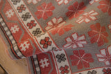 Distressed vintage Oushak rug's low pile with pale cherry red and oxidized silver patterns.