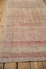 Distressed texture of vintage Oushak rug, showing wear, abrash, and muted red patterns.