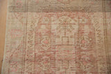Distressed Oushak runner detail with worn beige pile and visible red abrash wefting.