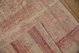 Distressed Oushak rug pile with foundation wear, red and white wefting, and side selvage.