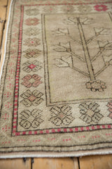 Patinaed Oushak rug featuring a tree of life, geometric serrated flowers, and meandering borders.