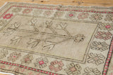 Vintage Distressed Oushak rug with raspberry serrated flowers and softened pile texture.