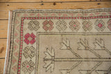 Distressed vintage Oushak rug with raspberry red geometric flowers and tree of life design.