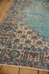 Textural detail of distressed vintage Sparta rug with powder blue stepped diamond and pomegranate border.