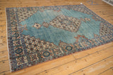 Distressed powder blue Sparta rug field, detailed pomegranate border, and intact side selvage.