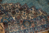 Distressed Vintage Sparta rug showing muted blue, beige patterns and worn pile.