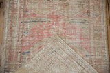 Back of a vintage Oushak rug showing the hand-knotted pile and woven cotton foundation.