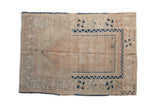 Vintage distressed Turkish Melas prayer rug in ivory, dusty rose, and cobalt geometric starburst patterns, 3' x 4'4