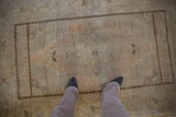 Vintage Distressed Oushak rug with faded apricot medallion and stepped corner spandrels.