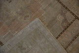 Distressed vintage Oushak rug reverse, revealing hand-knotted foundation and secured side cord.