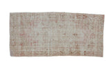 Distressed vintage Oushak rug runner, faded shield medallion, ivory and pink tones.