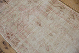 Distressed Oushak rug pile showing wear to knot heads and exposed foundation.