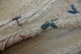 Thick cream shaggy pile and hand-knotted woven foundation of a vintage Tulu rug.
