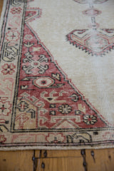 Corner of a distressed Sparta rug showing the low pile texture and foundation through the brick red pattern.