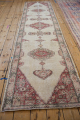 Angled view down the full length of a distressed Sparta runner with interconnected medallions.
