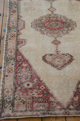 The worn, ribbed texture of a distressed Sparta rug with pale brick red and sand colored details.