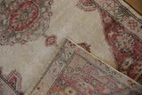 A folded corner of the distressed Sparta runner shows its worn texture, with visible knot heads and foundation.