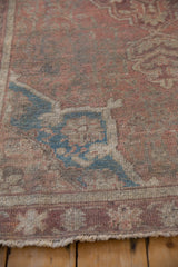 Worn dusty sapphire blue samovar corner spandrel on a vintage distressed Anatolian rug.
