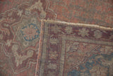 Distressed Anatolian rug showing worn pile, exposed foundation, and restored dusty mauve rose selvage.