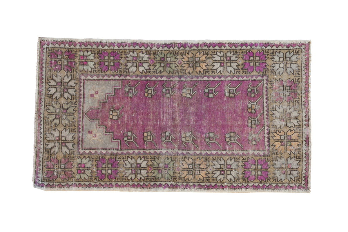Distressed vintage Oushak prayer rug with a purple field, stepped mehrab, and decorative saffron floral border.