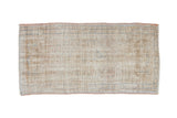 Distressed vintage hand-knotted Oushak runner with worn pile, cream, beige, and dusty blue.
