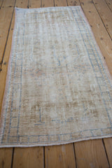 Distressed vintage Oushak runner with faded blue patterns and exposed foundation.