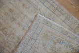 Distressed vintage Oushak rug showing worn pile and hand-knotted reverse.