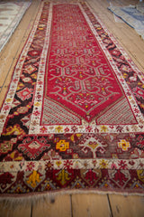 Low angle view of a cherry red Anatolian runner with geometric samovar motifs.