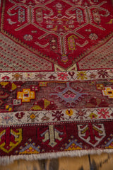 Low pile and visible knot heads on the geometric end borders of a vintage Turkish rug runner.
