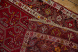 Folded corner of a hand-knotted Anatolian runner showing border detail and low-cut pile.