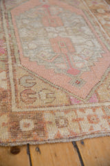 Distressed Oushak rug edge, highlighting low pile with soft pink, pale gold, oxidized silver tones.