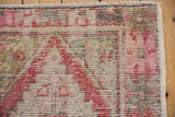 Distressed vintage Oushak rug's worn brick red pile and visible ivory foundation.
