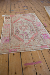 Distressed Oushak corner with faded rust and pale magenta, showing worn pile.