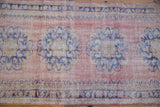 Textured distressed Oushak runner section with dusty pink and faded cobalt blue floral motifs.