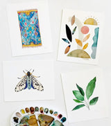 Four diverse watercolor art prints, including Earth & Sky No. 13, and a paint palette.