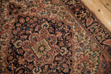 Hand-knotted vintage Farahan Sarouk rug detail, curvilinear floral motifs in navy, dusty blush, beige.