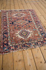 Geometric Karaja rug borders with crab starburst and meandering vine motifs in brick red.