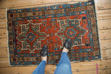 Primitive vintage Karaja rug featuring geometric double medallions in vibrant jewel tones.