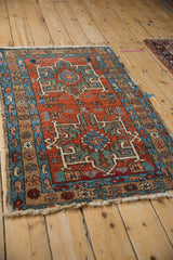 Vintage Karaja rug corner: brick red field, sapphire blue borders, boteh, and palmette motifs.