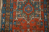 Brick red Karaja rug field with sapphire blue and mallard green serrated palmette motifs.