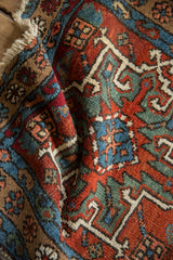 Vintage Karaja rug detail: primitive geometric patterns in rich brick red, sapphire, and jade green.